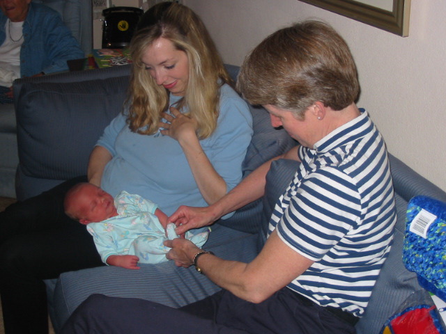 Kathleen & mom attend to baby